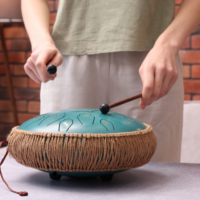person playing handpan drum for a relaxing music class.